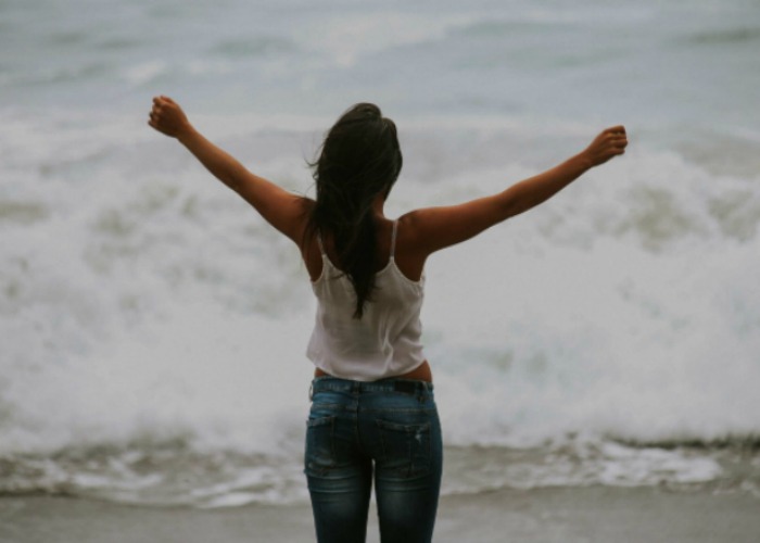 Happy woman on beach - Solverboard Social