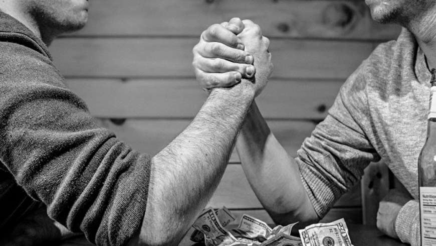 A fair day’s pay - two men arm wrestling.